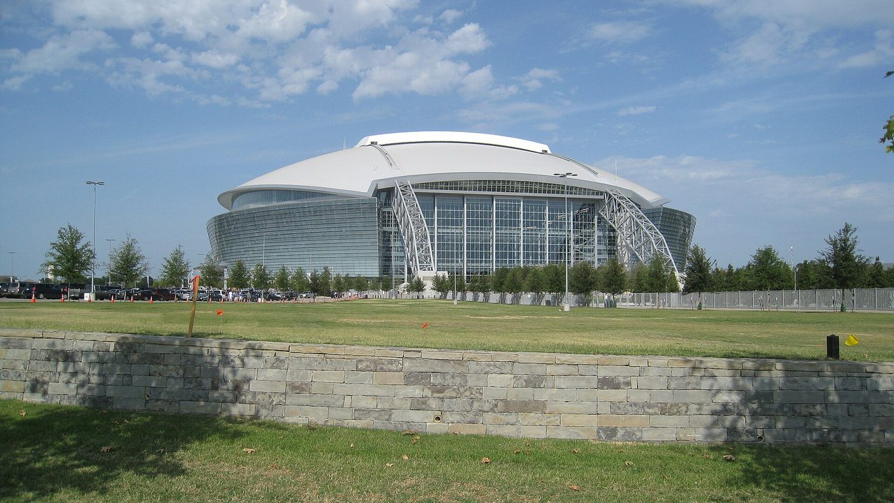 Real photo of the domed stadium in Arlington, Texas, with its glass walls and twin arches